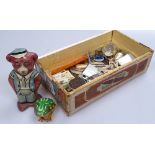 A mixed box of items, including tinplate clockwork bear and frog, desk items, pocket lighters,
