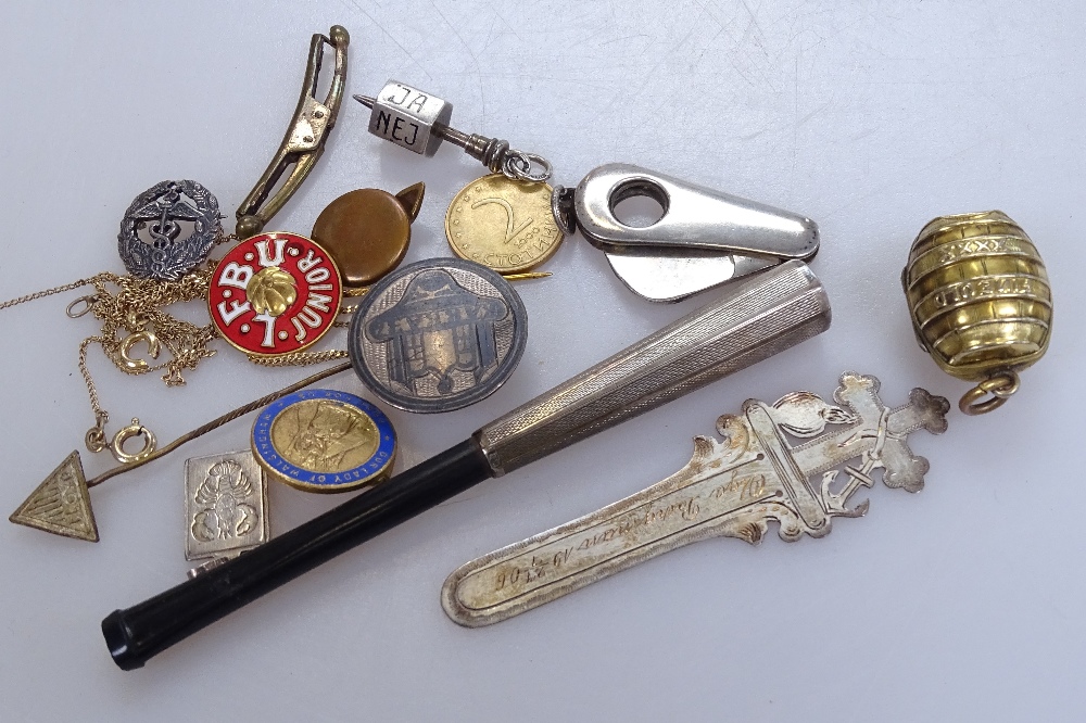 A group of miniature items, including a novelty barrel-shaped photo case, a silver bookmark, a cigar