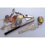 A group of miniature items, including a novelty barrel-shaped photo case, a silver bookmark, a cigar