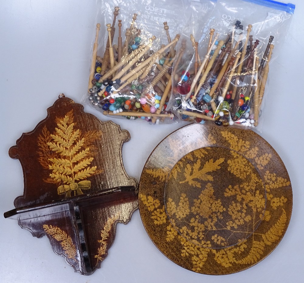 A collection of lace maker's bobbins, and a Furnware wooden folding wall rack, and a Furnware plate