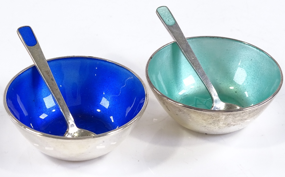 A pair of Danish sterling silver and coloured enamel salts with matching spoons, by Anton Michelsen,