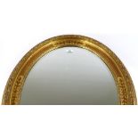 A Victorian style gilt-framed oval wall mirror, 84cm x 64cm