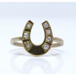 An unmarked gold diamond horseshoe ring, setting height 13.9mm, size N, 2.8g