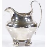 A silver bulbous cream jug, with reeded handle and bun feet, indistinct hallmarks, height 12cm, 4oz