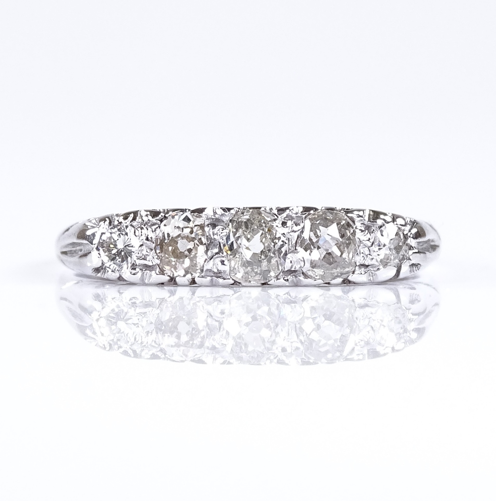 An 18ct white gold 5-stone diamond ring, pierced scrollwork bridge, setting height 4mm, size R, 2.5g