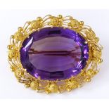 An unmarked gold cannetille and amethyst brooch, length 33.1mm, 8.9g