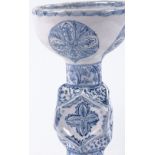 An Islamic blue and white pottery candle stand, height 23cm