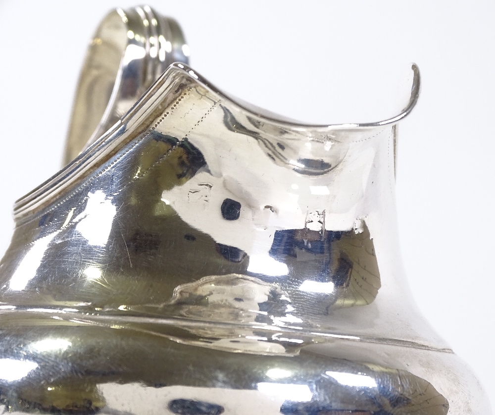 A silver bulbous cream jug, with reeded handle and bun feet, indistinct hallmarks, height 12cm, 4oz - Image 3 of 3