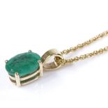 A 9ct gold emerald pendant necklace on a 9ct rope link chain, oval-cut emerald approx 0.69ct,