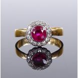 A 22ct gold ruby and diamond cluster flowerhead ring, ruby approx 1ct, setting height 10.7mm, size