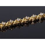 An unmarked gold XO diamond set tennis line bracelet, total diamond content approx 1.4ct, length