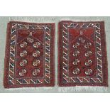 A pair of Caucasian handmade red ground geometric pattern rugs