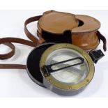 An artillery prismatic compass by Francis Barker & Son, diameter 12cm, in original leather case
