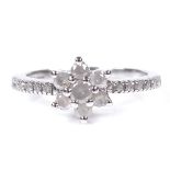A 9ct white gold diamond cluster flowerhead ring, with diamond set shoulders, total diamond
