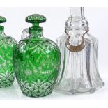 A pair of green overlay cut-glass flasks, with original overlay stoppers, height 18cm, and a glass
