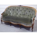A Victorian mahogany-framed parlour sofa, with floral carved show wood surround, shaped front and