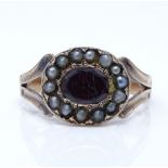 An unmarked gold garnet and pearl cluster memorial ring, setting height 10.9mm, size O, 2.9g