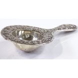 An American sterling silver wine strainer, with relief grapevine decoration, model no. 2610,