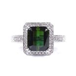 A 14ct white gold green tourmaline and diamond cluster ring, emerald-cut tourmaline approx 3.2ct,