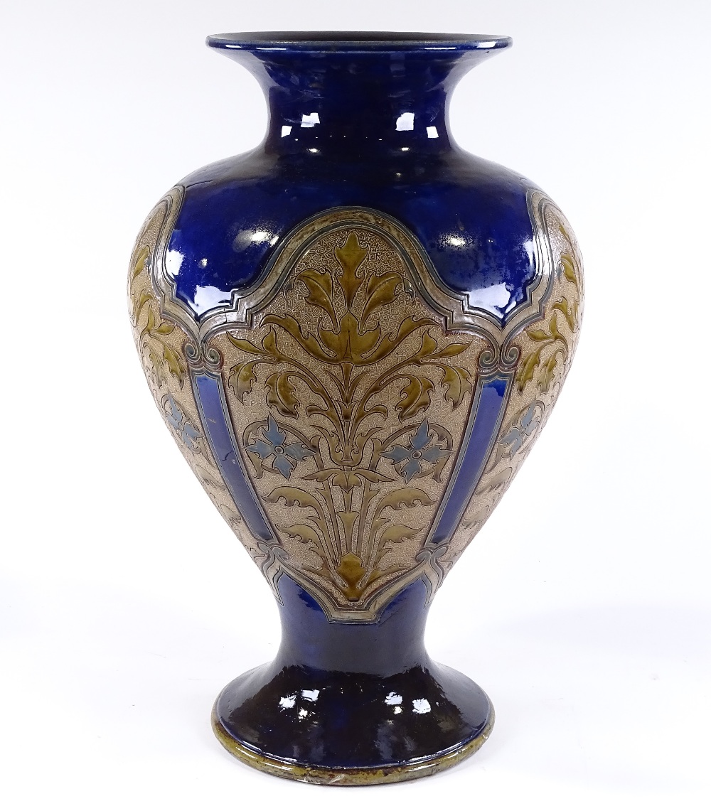 A large Royal Doulton stoneware blue ground vase, circa 1900, with panels of incised floral