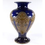 A large Royal Doulton stoneware blue ground vase, circa 1900, with panels of incised floral