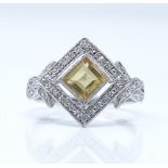 A 9ct white gold citrine and diamond cluster ring, setting height 13.8mm, size M, 1.9g