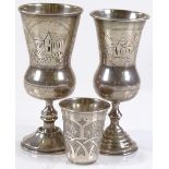 A pair of Russian silver thistle-shaped goblets, together with a Russian silver drinking tot dated