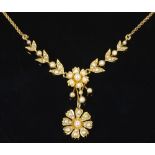 An unmarked gold and pearl floral pendant necklace, on unmarked gold rope twist chain, length 390mm,