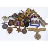 A collection of military medals, badges, buttons and ribbons