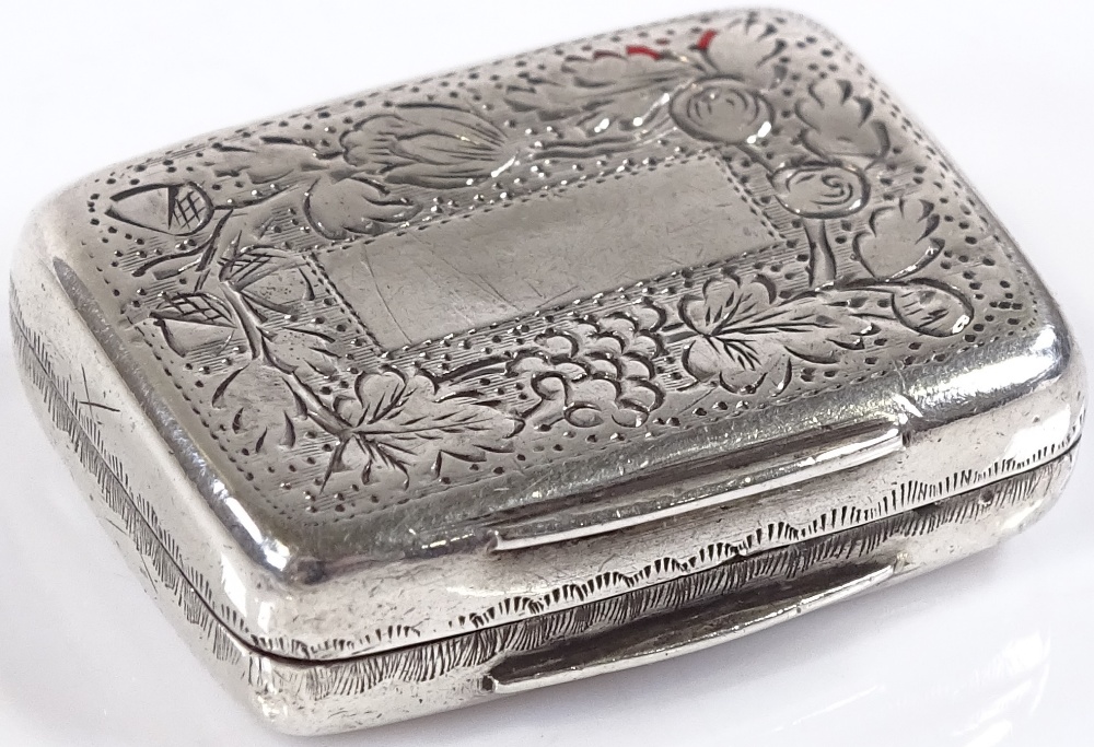 A miniature rectangular silver vinaigrette, with circular pierced grille and floral engraved