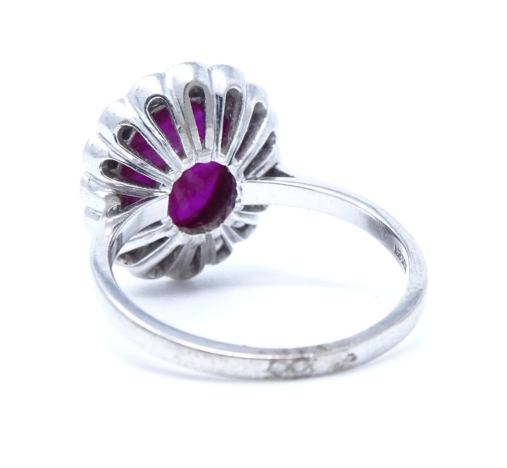 An 18ct white gold cabochon ruby and diamond cluster ring, ruby dimensions 9.6mm x 7.36mm x 3. - Image 3 of 4