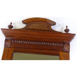 A 19th century carved oak-framed wall mirror, with shaped pediment, overall height 1.13m (3'9")