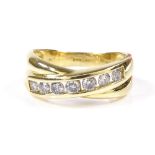 An 18ct gold 7-stone diamond crossover ring, channel set diamonds approx 0.5ct total, setting height