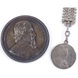 A silver commemorative medallion, diameter 6cm, and a silver coin-mounted fob