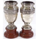 A pair of silver racing trophies on marble stands, for the Coupe Edgar Flasselaerts, dates for