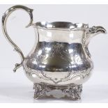 A Victorian silver cream jug, of bulbous form with foliate engraving and gilded interior, by