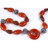 A long Chinese carnelian bead necklace, with engraved character mark hardstone spacers, and blue