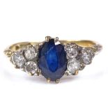 An 18ct gold sapphire and diamond dress ring, oval-cut sapphire approx 1ct, setting height 8.5mm,