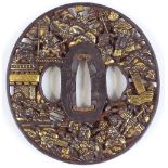 An Antique Japanese bronze patinated iron tsuba, finely detailed, relief moulded battle scenes, with