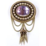 A Victorian oval memorial brooch, with foil-back domed cabochon rock crystal centre, surrounded by