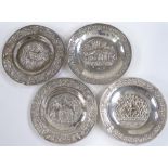 A group of 4 Indian white metal circular trays, with relief embossed village scenes, diameter 9cm,