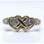A 9ct gold diamond double heart ring, setting height 7.6mm, size M, 2.9g