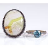 A 9ct gold single stone blue zircon ring, size O, together with a silver and agate panel ring,