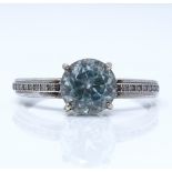 An unmarked white gold blue topaz solitaire ring, with diamond set shoulders, setting height 8mm,