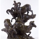 A patinated bronze sculpture depicting mountain goats on a rocky outcrop, black marble plinth,