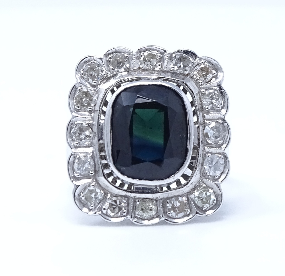 An 18ct white gold sapphire and diamond cluster ring, setting height 19.6mm, size L, 7.3g