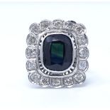 An 18ct white gold sapphire and diamond cluster ring, setting height 19.6mm, size L, 7.3g