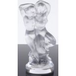 A Rene Lalique moulded glass sculpture of Pan holding a naked woman, engraved Lalique France under