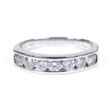 An 18ct white gold 7-stone diamond half-hoop ring, channel set diamonds approx 1ct total, setting
