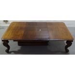 A large Victorian mahogany extending dining table on heavy carved and scrolled cabriole legs, 4